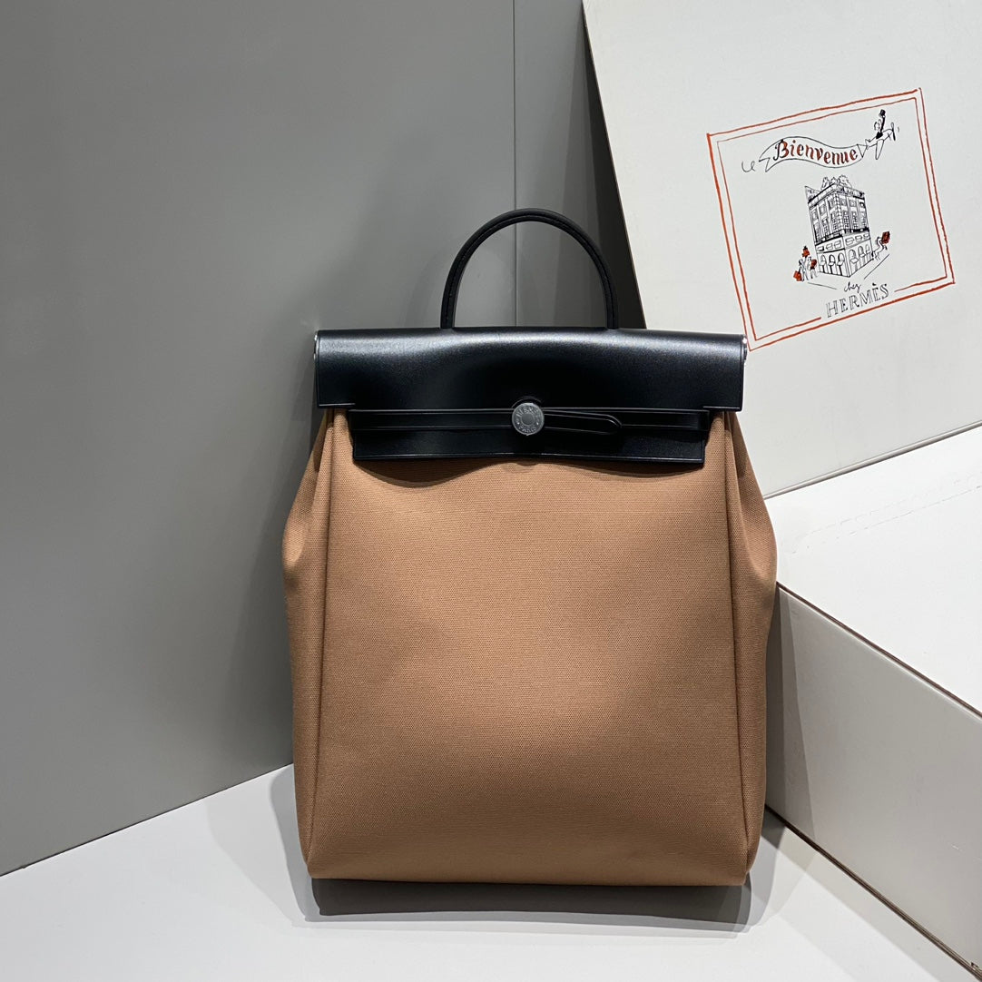 HERBAG A DOS ZIP RETOURNE BACKPACK 29 IN BROWN CANVAS AND BLACK CALFSKIN