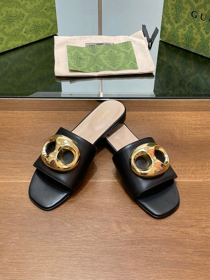 FLAT MULE IN BLACK CALFSKIN WITH GOLD HARDWARE